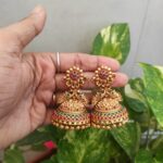 httpsshop.southindiajewels.comwp-contentuploads202010Flower-Design-Red-Green-Stone-Jhumka-01-scaled-1.jpg